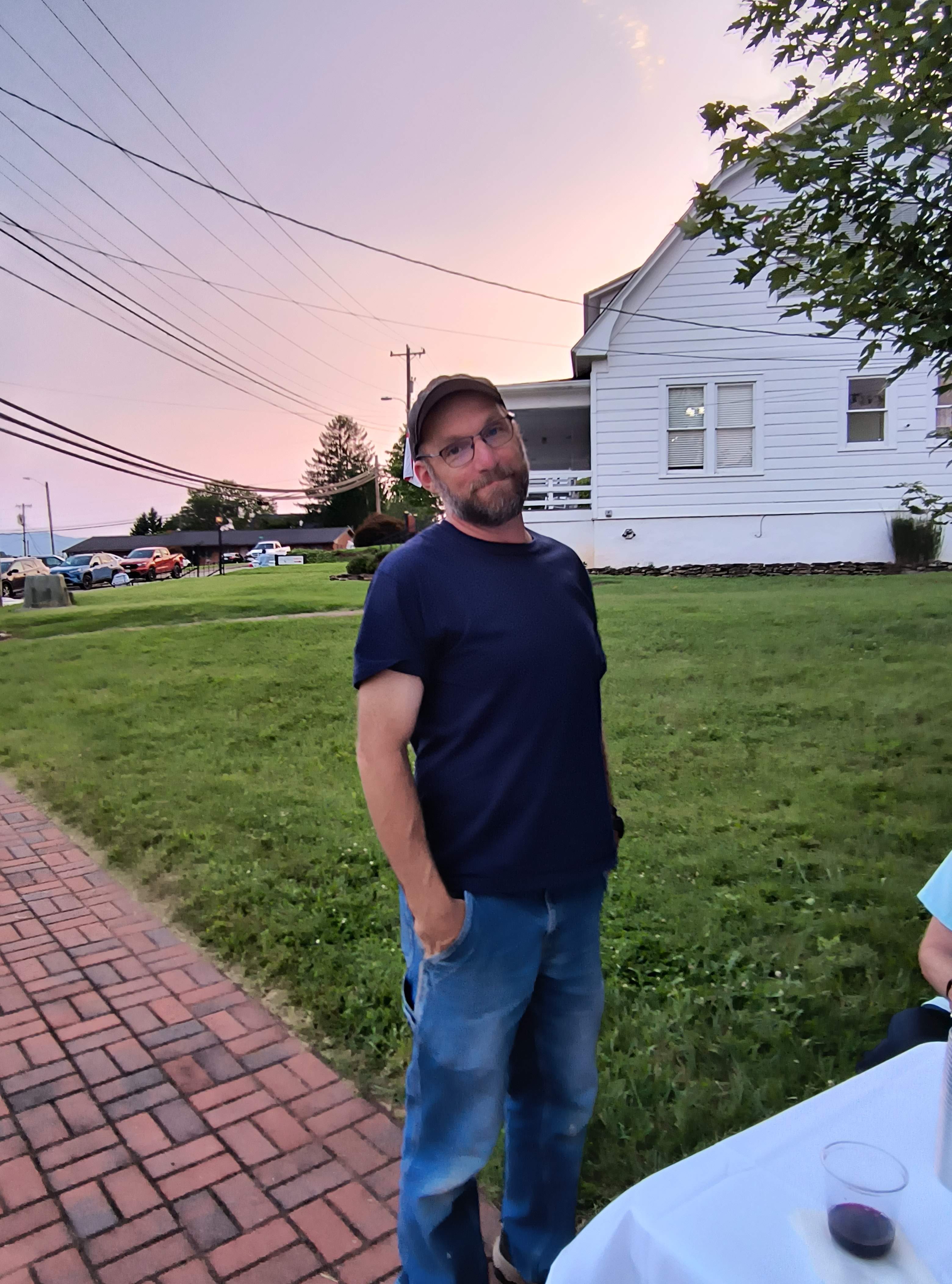 A guest on the church lawn at sunset during the reception