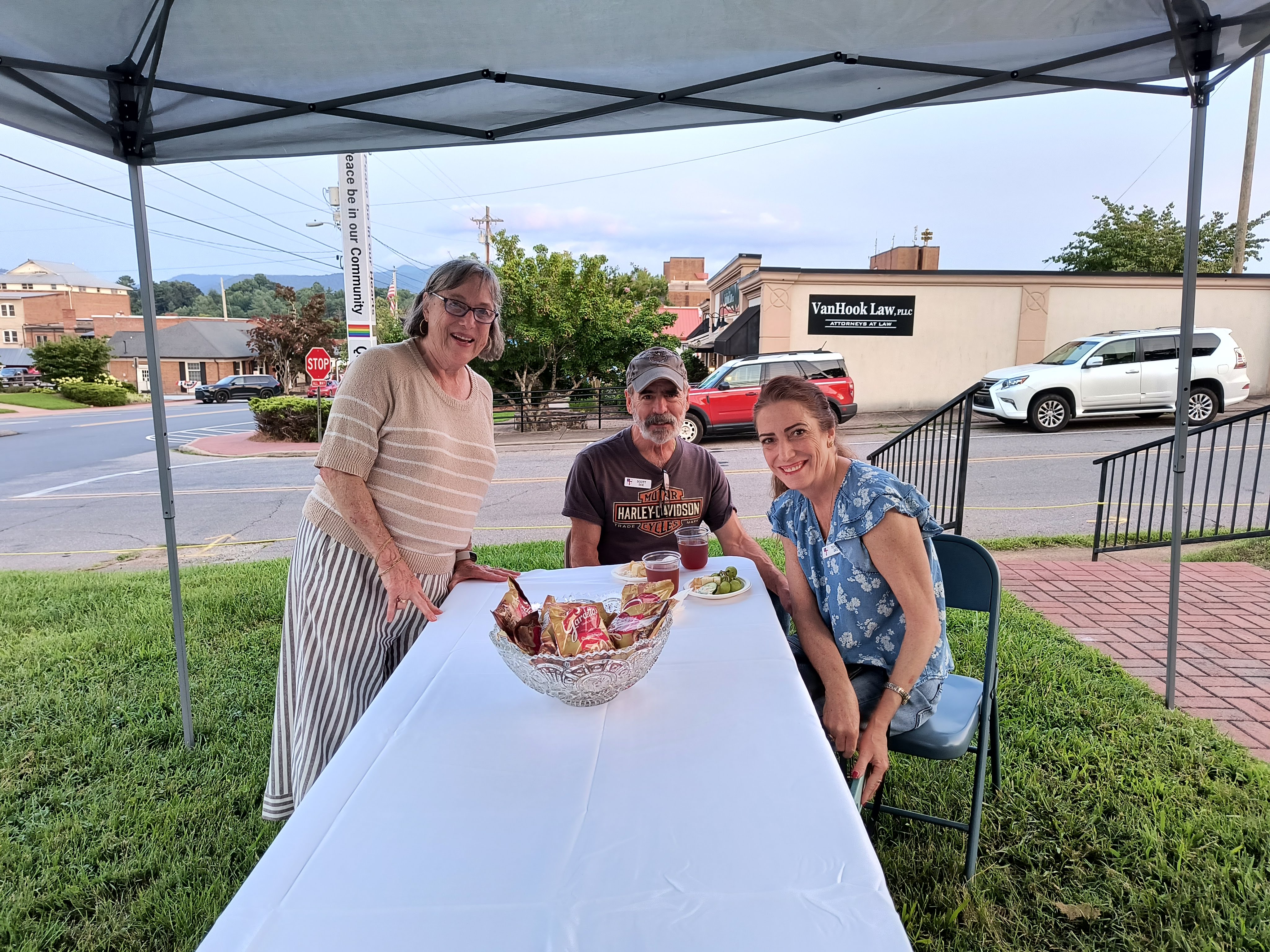 Three guests at a reception table with downtown Franklin in the background