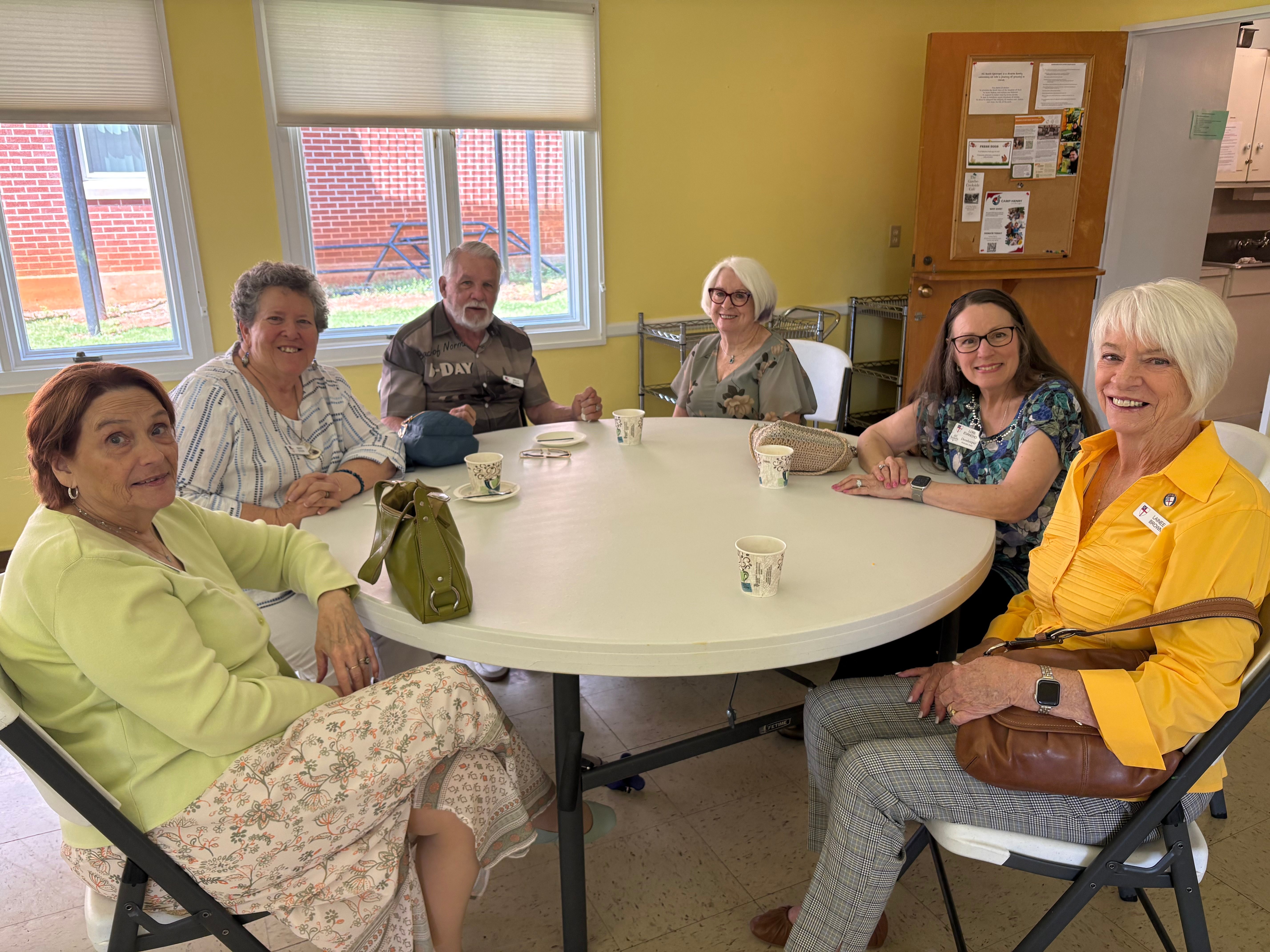 Parishioners gathered around a table sharing coffee and conversation
